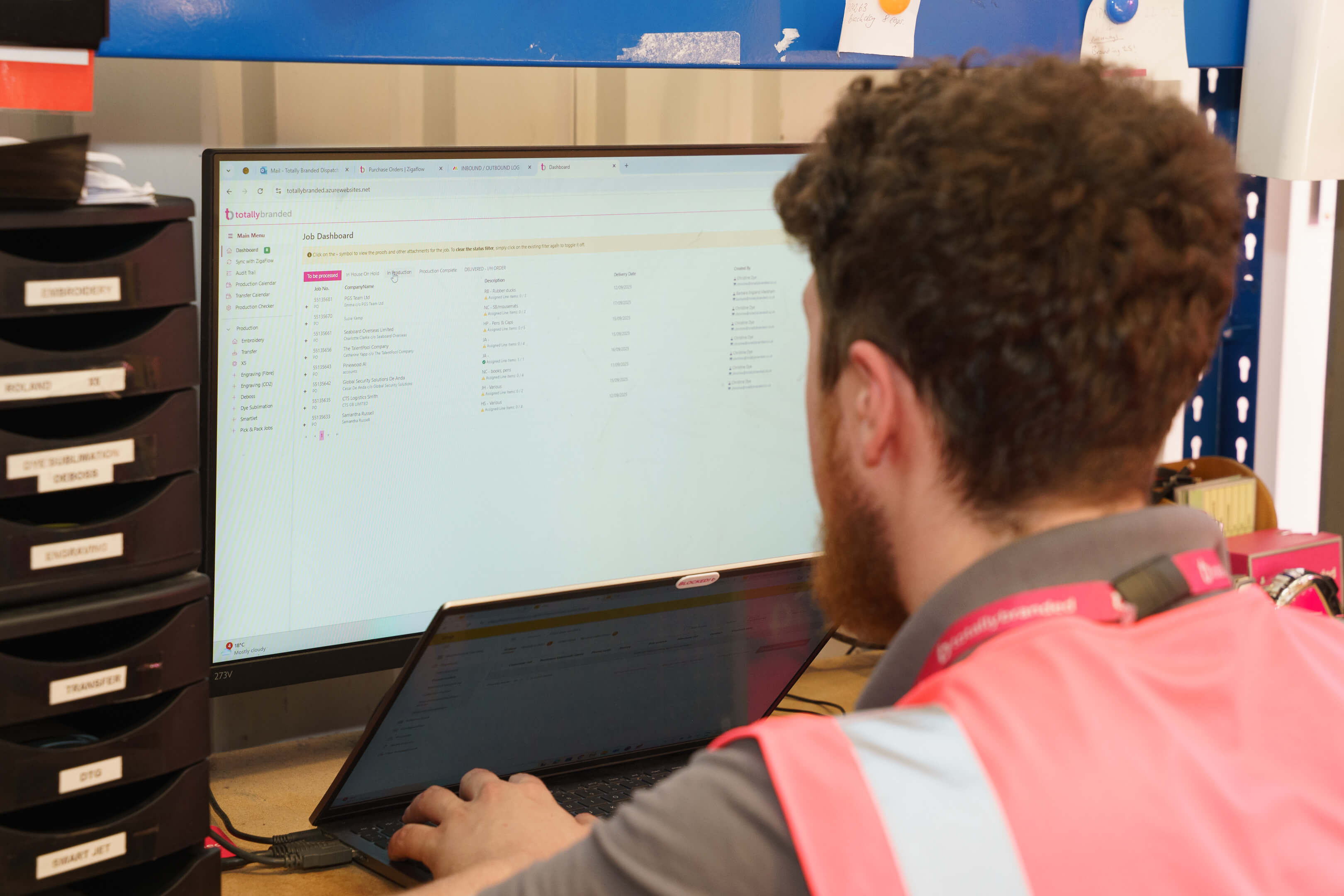 Totally Branded staff member is using the production system tool.